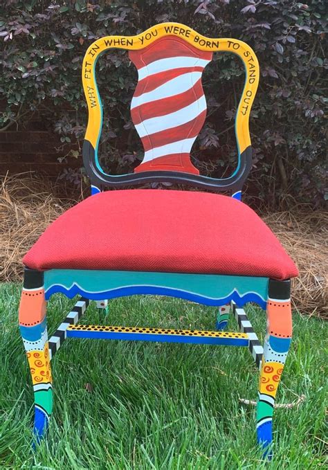 A Colorful Painted Chair Sitting In The Grass