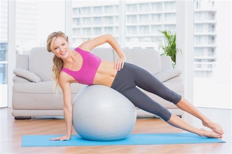 Premium Photo Cheerful Fit Blonde Doing Side Plank With Exercise Ball