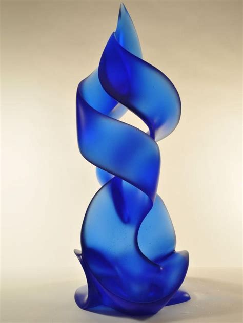 A Blue Glass Sculpture Sitting On Top Of A Table