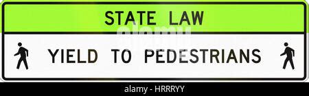 Sign State Law Yield To Pedestrians Within Crosswalk Stock Photo