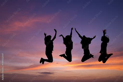 Silhouette of young people jumping together,friend having fun,happy friends with sunset ...