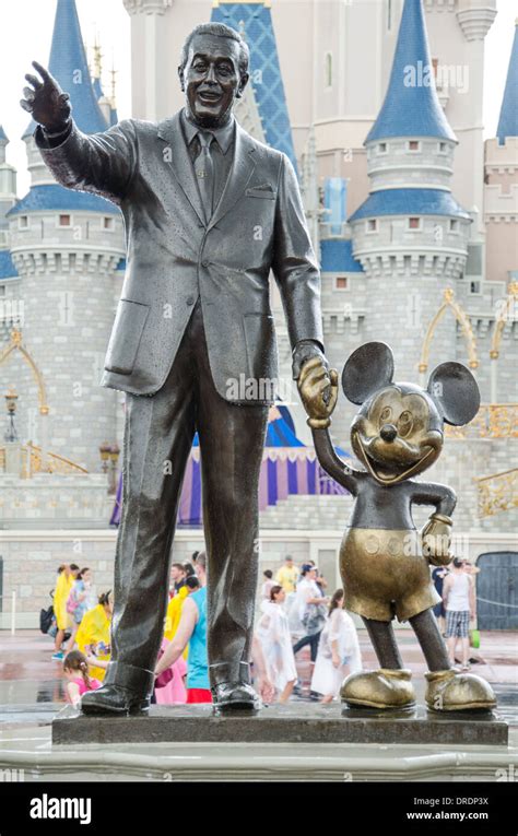 Statue Of Walt Disney And Mickey Mouse In Front Of The Castle In Magic