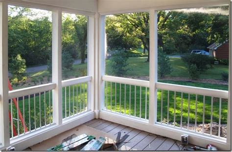 Screen Porch With White Railings And Glass Doors