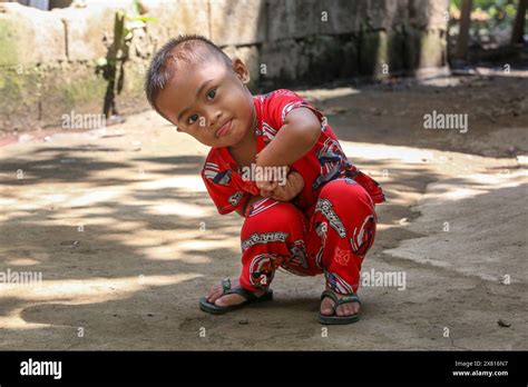 A Young Filipino Boy Play With The Camera By Posing And Asking For More