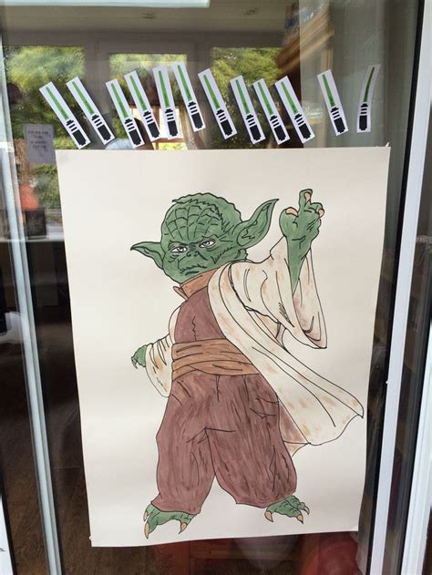 Pin the lightsaber on Yoda