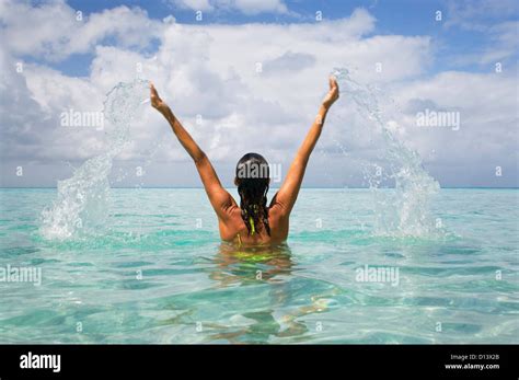 Woman Splashing In Tropical Ocean Water Stock Photo Alamy