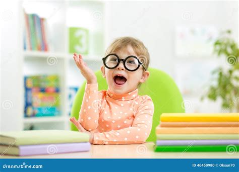 Portrait Of Clever Kid Girl With Books Indoor Stock Photo Image Of