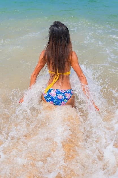 Premium Photo Rear View Of Woman Wearing Bikini At Beach