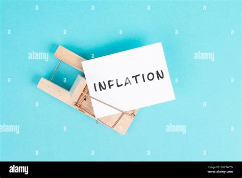 Paper With The Word Inflation In A Mousetrap High Financial Burden