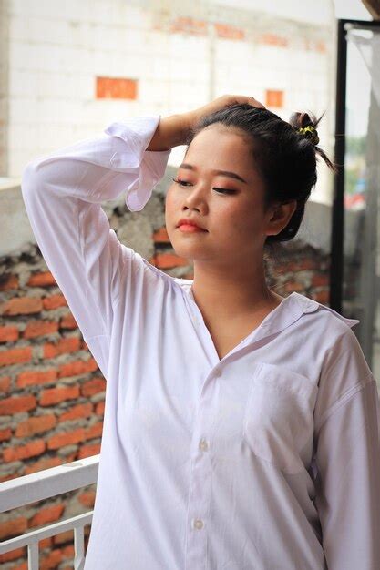 Premium Photo Portrait Of Teenage Girl Standing Against White Wall