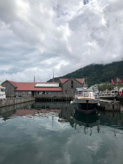 Premium Photo Boats Moored In Lake By Buildings Against Sky