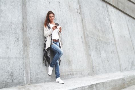 Premium Photo Young Woman Holding A Mobile Phone In Hands