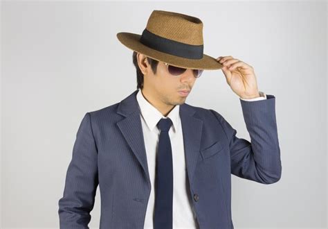 Premium Photo Midsection Of Man Wearing Hat Against White Background