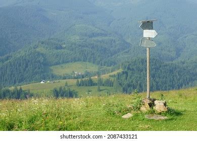 Blank Directional Road Signs Against Mountain Stock Photo 2087433121