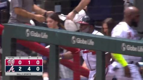 The Braves' first base coach, Eric Young Sr., makes sure the Nationals ...