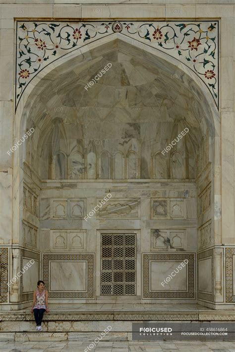 Woman Sitting On A Wall At The Taj Mahal Agar Uttar Pradesh India