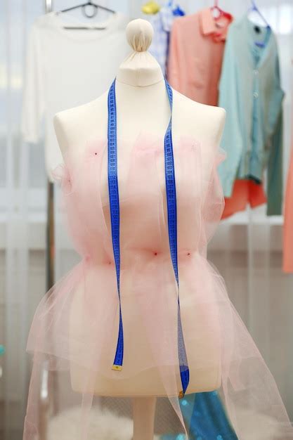 Premium Photo Tailor Dummy With Measuring Tape In Fashion Studio