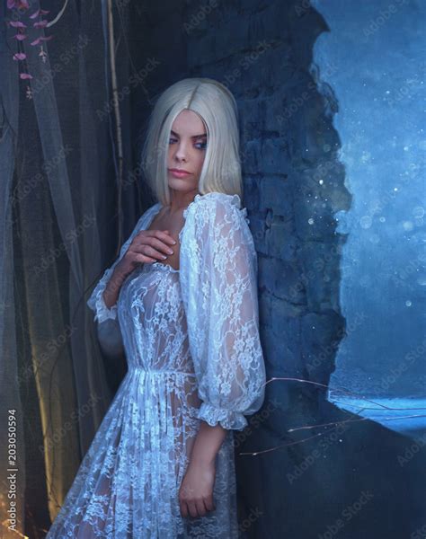 Sexy Gothic Snow Queen In A White Vintage Dress A Blond Girl With Very Long Hair Posing