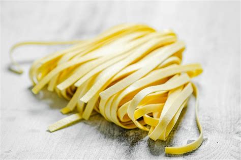 Premium Photo Homemade Pasta Tagliatelle On A White Table