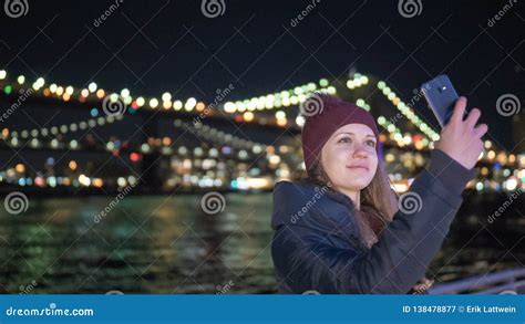 Girl Takes A Selfie Photo At Brooklyn Bridge By Night Stock Image