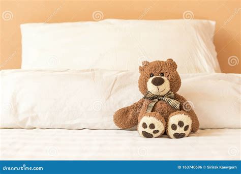 Brown Teddy Bear Sitting Alone on the Bed Stock Photo - Image of ...