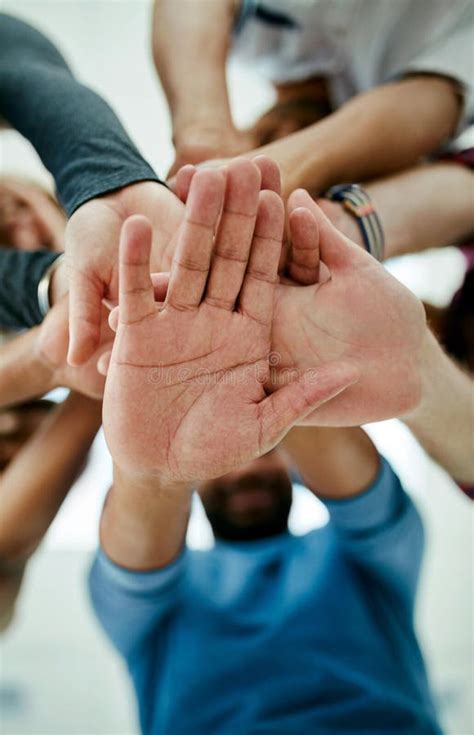 Theyre In It To Win It Low Angle Shot Of A Young Design Teams Hands In