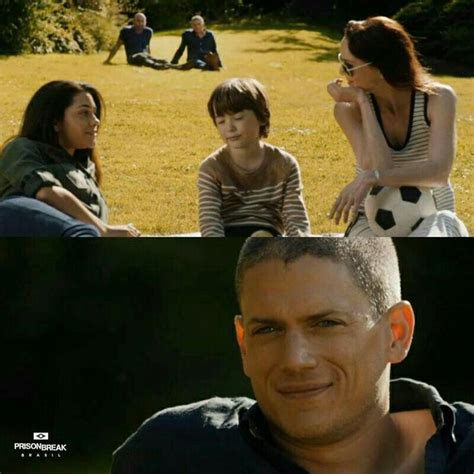 Three People Sitting In The Grass With One Person Holding A Soccer Ball