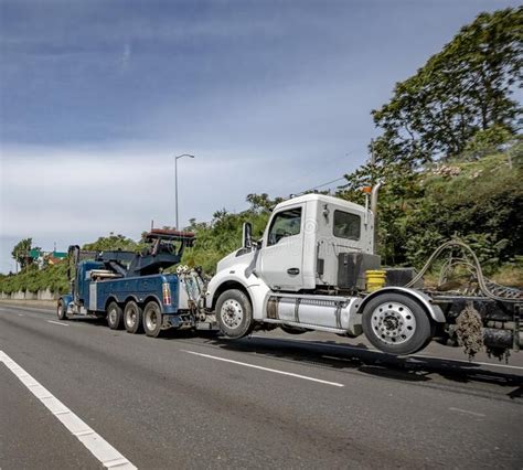 Dark Blue Big Rig Day Cab Semi Truck Transporting Cargo In Bulk Semi