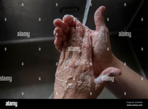 Someone Washing Their Hands In The Sink Stock Photo Alamy