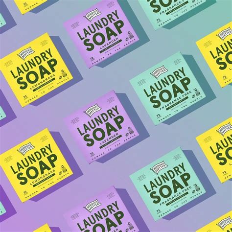 Several Boxes Of Laundry Soap On A Purple And Green Background