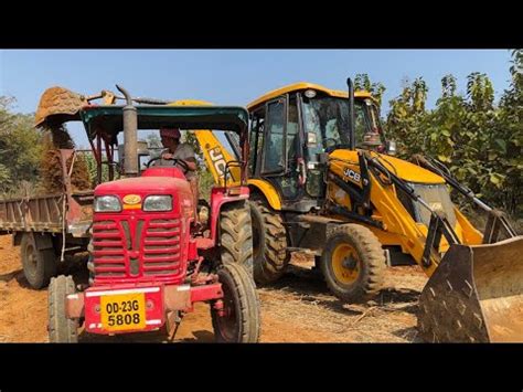 Jcb Dx Eco Excellence Backhoe Machine Loading Mud In Mahindra Di