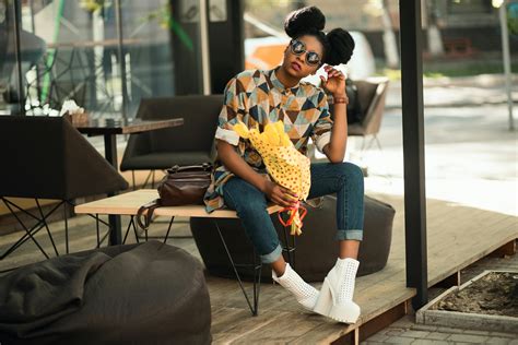 woman wearing brown floral print coat  pants sitting  car