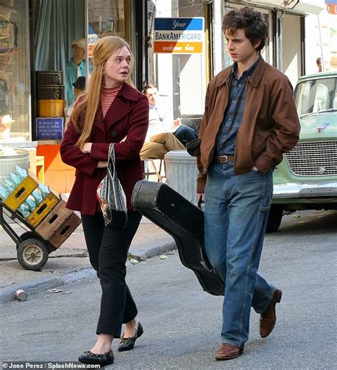 Timothee Chalamet Carries A Guitar Case As He Films Scenes With Co Star Elle Fanning In New