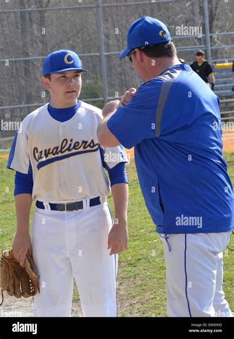 Baseball Coach Talking To A Player During A High School Baseball Game