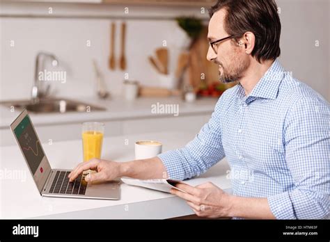 Cheerful Mature Businessman Enjoying Freelance Responsibilities At Home