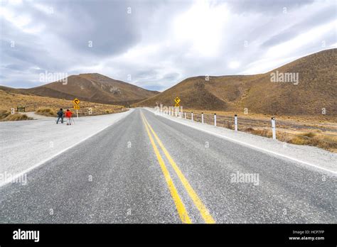 Asphalt Road With Lenticular Cloud At South Of New Zealand Stock Photo