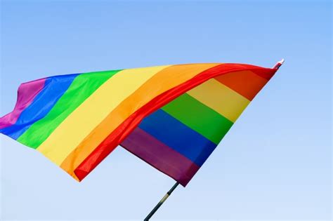 Premium Photo Gay Rainbow Flag Waving In The Wind In A Clear Blue Sky