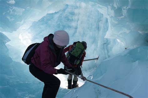 Descending Down An Ice Cave At Franz Josef Glacier South Island New