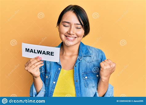 Beautiful Young Woman With Short Hair Holding Malware Paper Screaming Proud Celebrating Victory