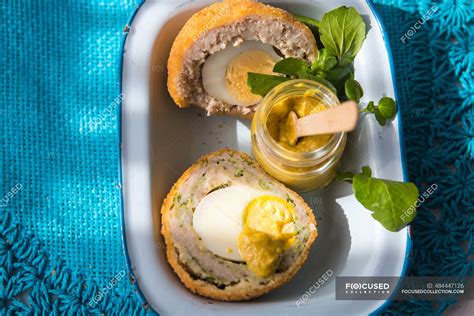 Scotch eggs with mustard — topview, mustard jar - Stock Photo | #484447126