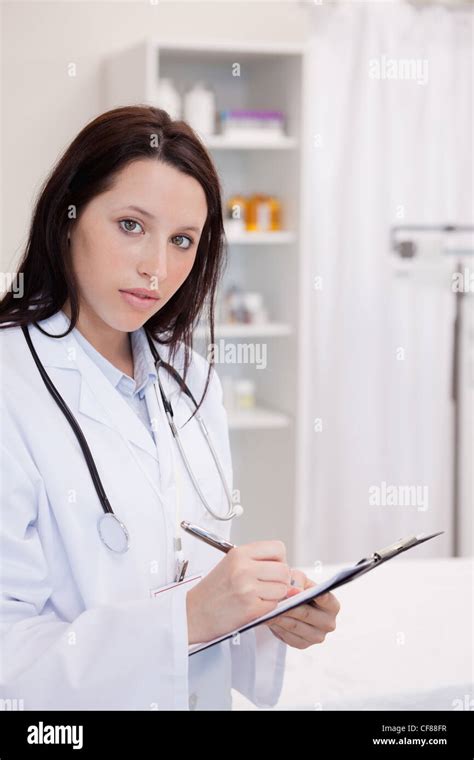 Female Doctor Writing On Her Notepad Stock Photo Alamy