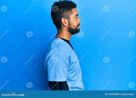 Handsome Hispanic Man With Beard Wearing Blue Male Nurse Uniform