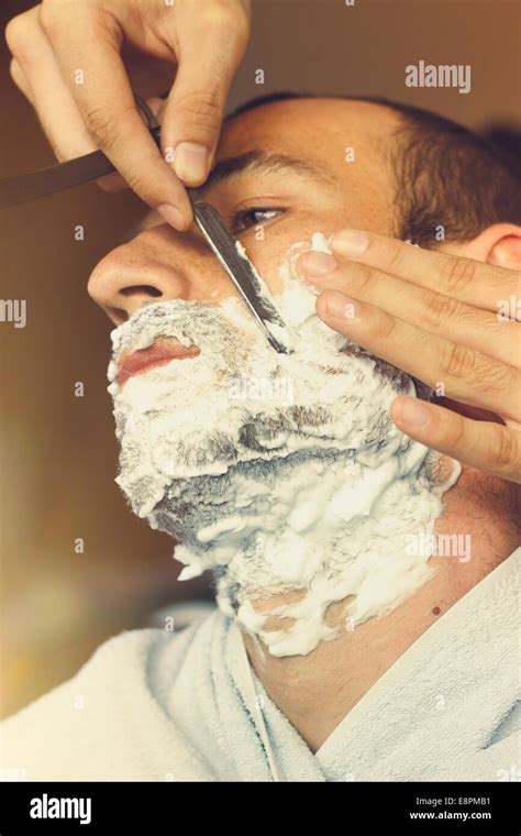 Young man getting old fashioned shave hi-res stock photography and ...