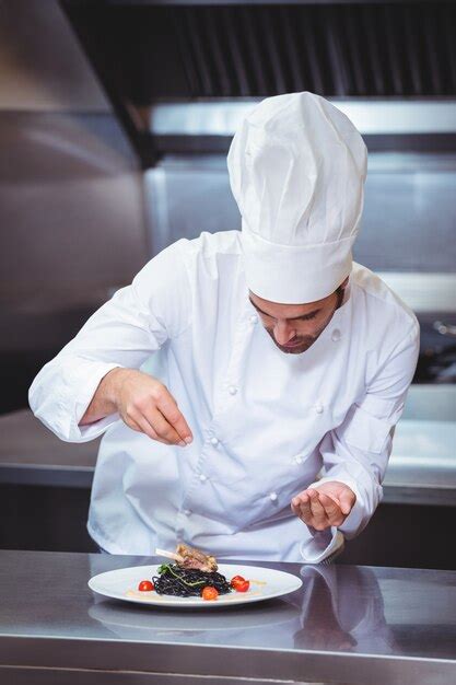 Premium Photo Chef Sprinkling Spices On Dish