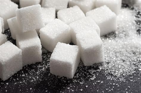 Premium Photo Cubes Of Refined Sugar On A Dark Table Closeup