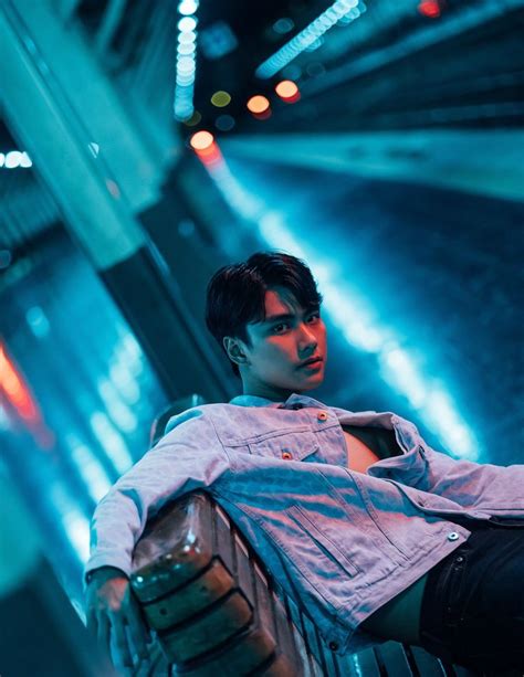 A Man Sitting On A Bench In The Middle Of A Tunnel With His Legs Crossed