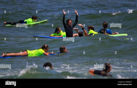 Gilgo Beach, New York, USA - 25 July 2023: Kids in neon green shirts ...