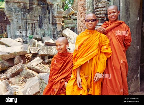 3 Monks Playing With Sunglasses At The Ta Prohm Temple In Cambodia