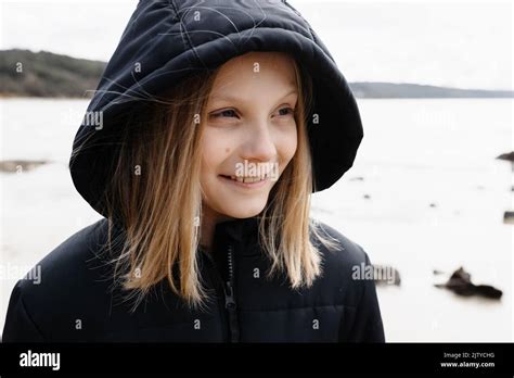 A Causcasian Blonde Girl Wearing A Warm Jacket Walking On A Beach In Winter Stock Photo Alamy