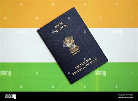 Blue Indian Passport On National Flag Background Close Up Tourism And Citizenship Concept Stock